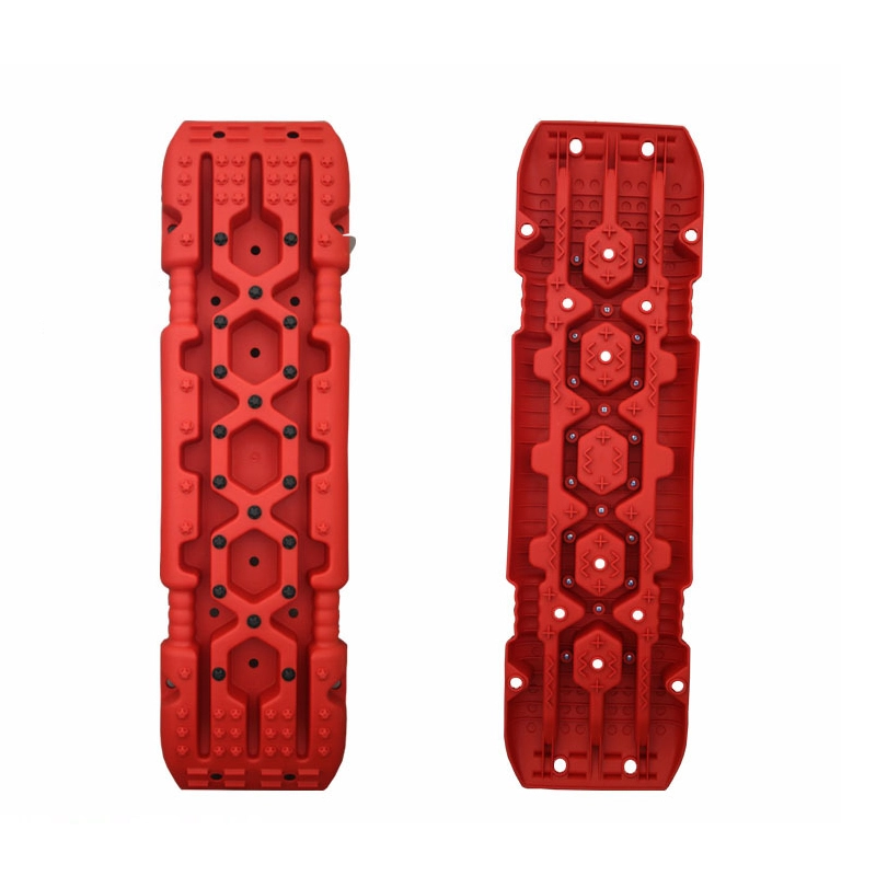 Red heavy duty traction boards showing detailed tread and bolt structure