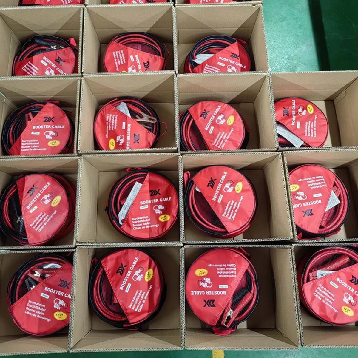 Red booster cables packed neatly in cartons – wholesale packaging