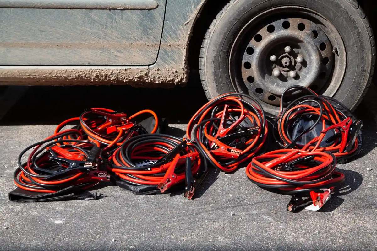 Multiple sets of booster jumper cables displayed outdoors for demonstration