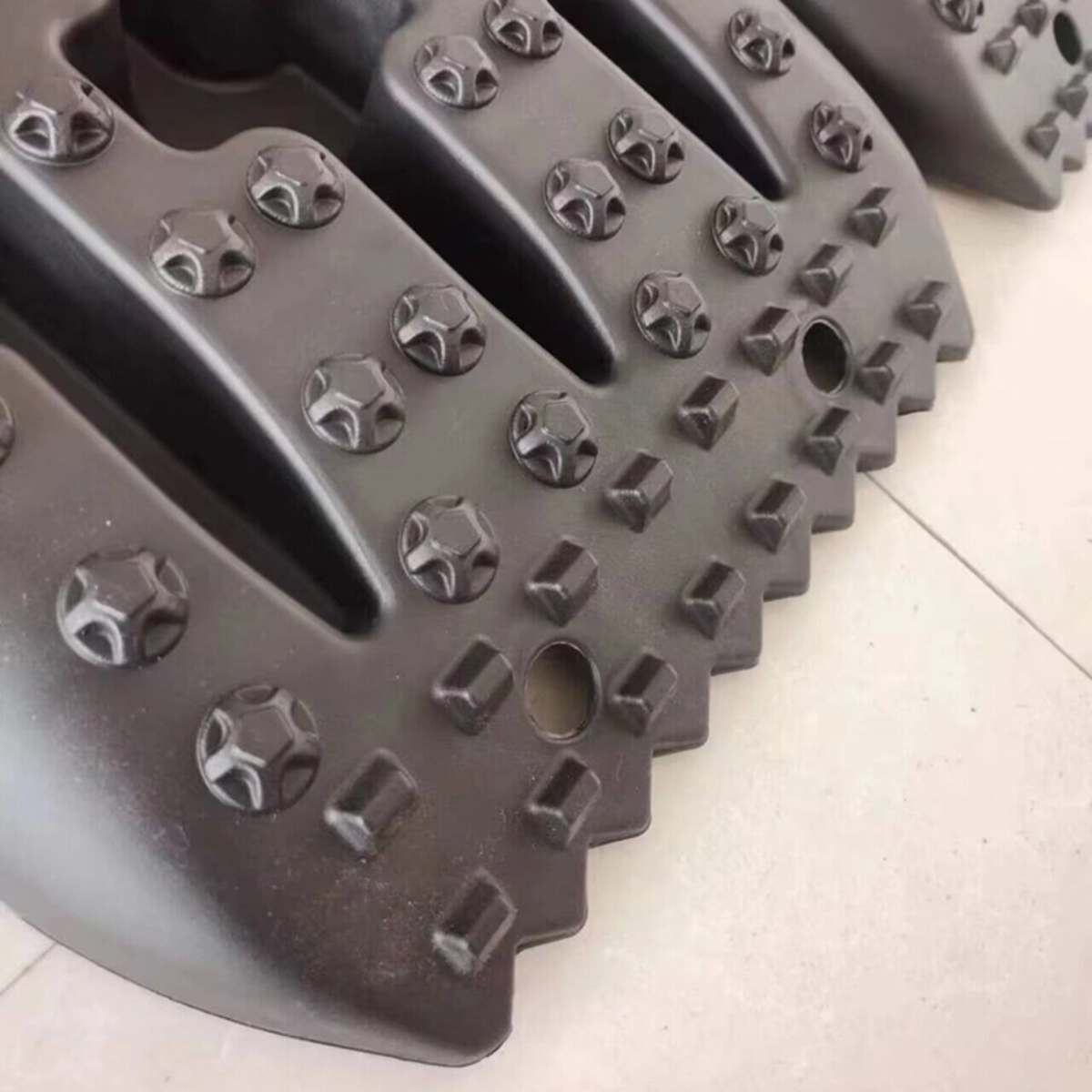 Close-up of traction board lugs and teeth for enhanced grip in mud or sand