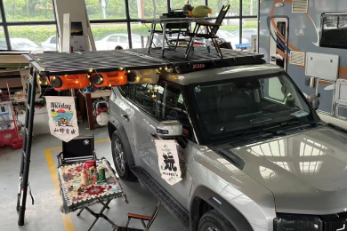 Camping setup with SUV roof rack platform, awning, and outdoor gear