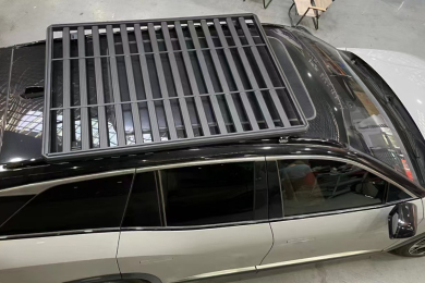 Top view of a black SUV equipped with a full-length roof rack platform